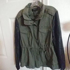 Green jacket with faux leather arms.